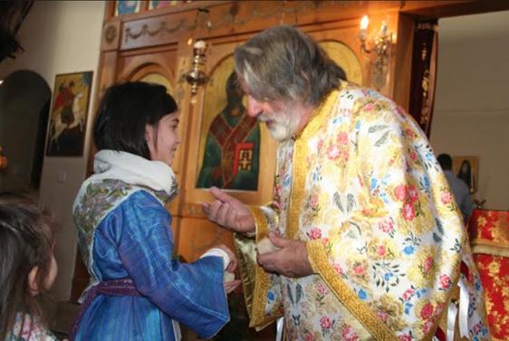 Girl dressed in tradition Kalymnos attire greets Archbishop of Thyateira & Great Britain in Southampton